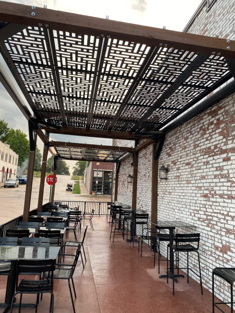 Outdoor pergola with laser cut panels