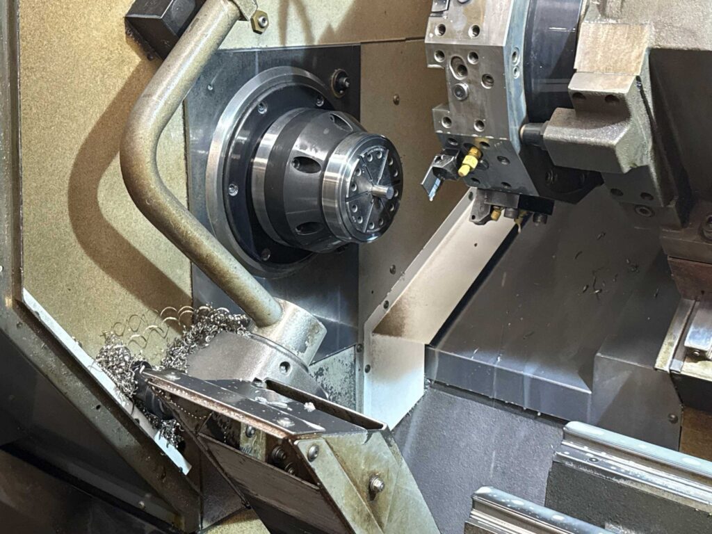 CNC lathe chuck and tool turret inside a Red Oak Fabrication turning center