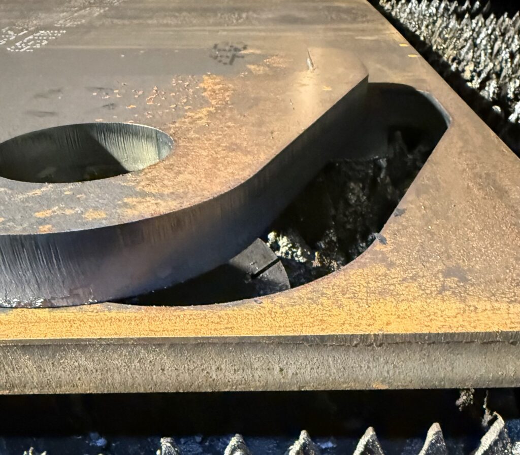 Close-up of a laser-cut edge on thick steel plate