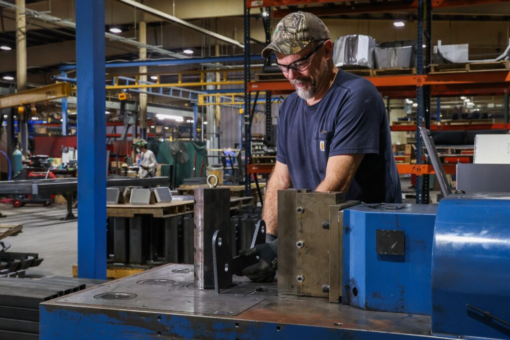 Operator setting up a part in the horizontal hydraulic press