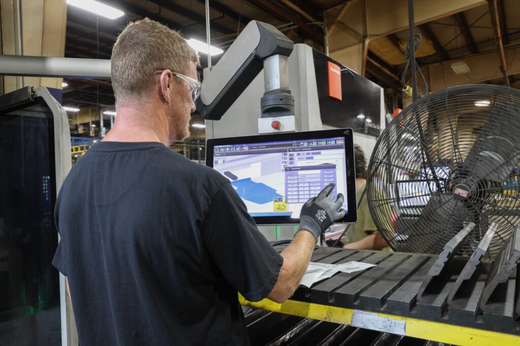 Operator programming a bend at the press brake control screen